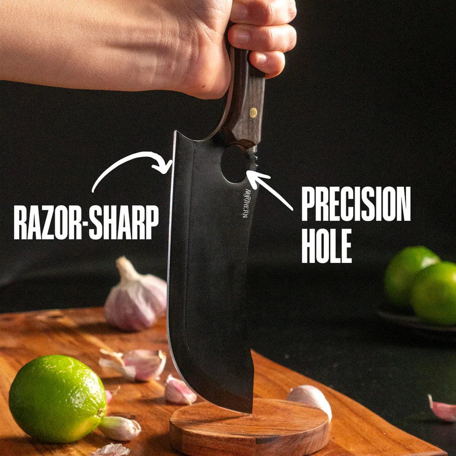 Close-up of the Loki knife slicing a lime on a wooden board, highlighting its sharp blade and precision hole.