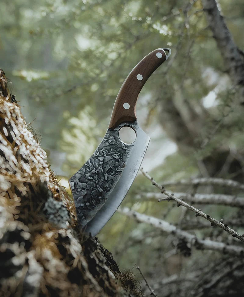Close-up of a NorthernKnife embedded in a tree, highlighting its durable build and lifetime warranty.