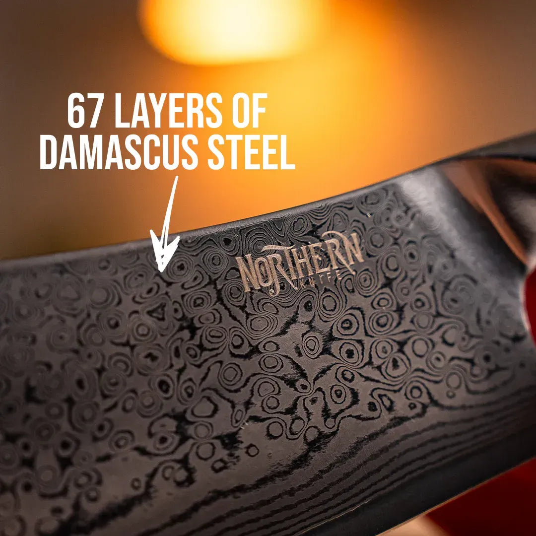 Close-up of a Northern Knife blade showing the intricate pattern of 67 layers of Damascus steel with an engraved brand logo.